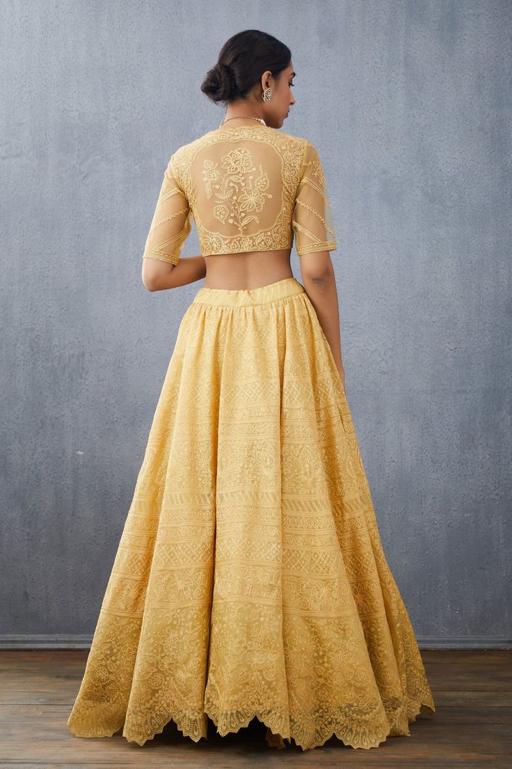 Mustard silk organza lehenga with floral hand embroidered motifs and scallop cutwork border. Paired with embroidered blouse and embroidered silk organza dupatta.
Component: 3
Pattern: Embroidered
Type Of Work: Floral
Neckline: V Neck
Sleeve Type: Elbow Sleeves
Fabric: Silk Organza
Color: Yellow
Other Details: 
Scallop cutwork border
Hand embroidery
Sheer sleeves and back
Side tassel tie-up
Occasion: Bride,Wedding - Aza Fashions Organza Lehenga, Yellow Silk, Organza Dupatta, Silk Organza, Elbow Sleeve, Bridal Lehenga, Cut Work, Sheer Sleeves, Embroidered Silk