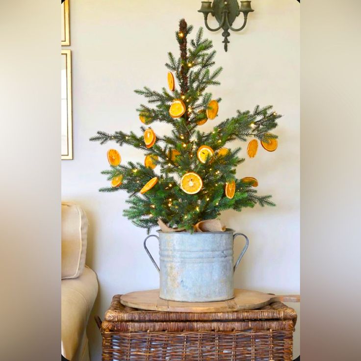 a potted christmas tree sitting on top of a wooden table next to a wall