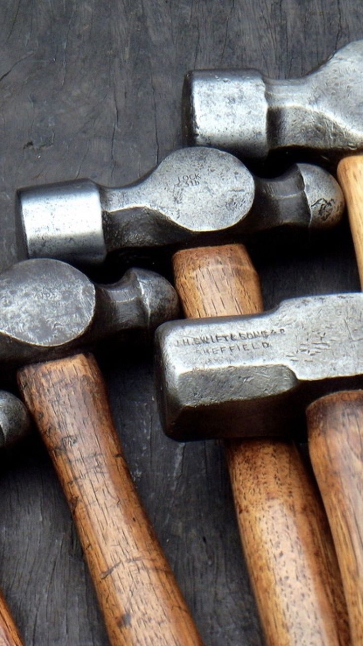 several different types of hammers are lined up in a row on top of each other