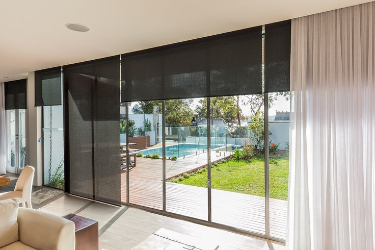 an open living room with sliding glass doors leading to the swimming pool and patio area