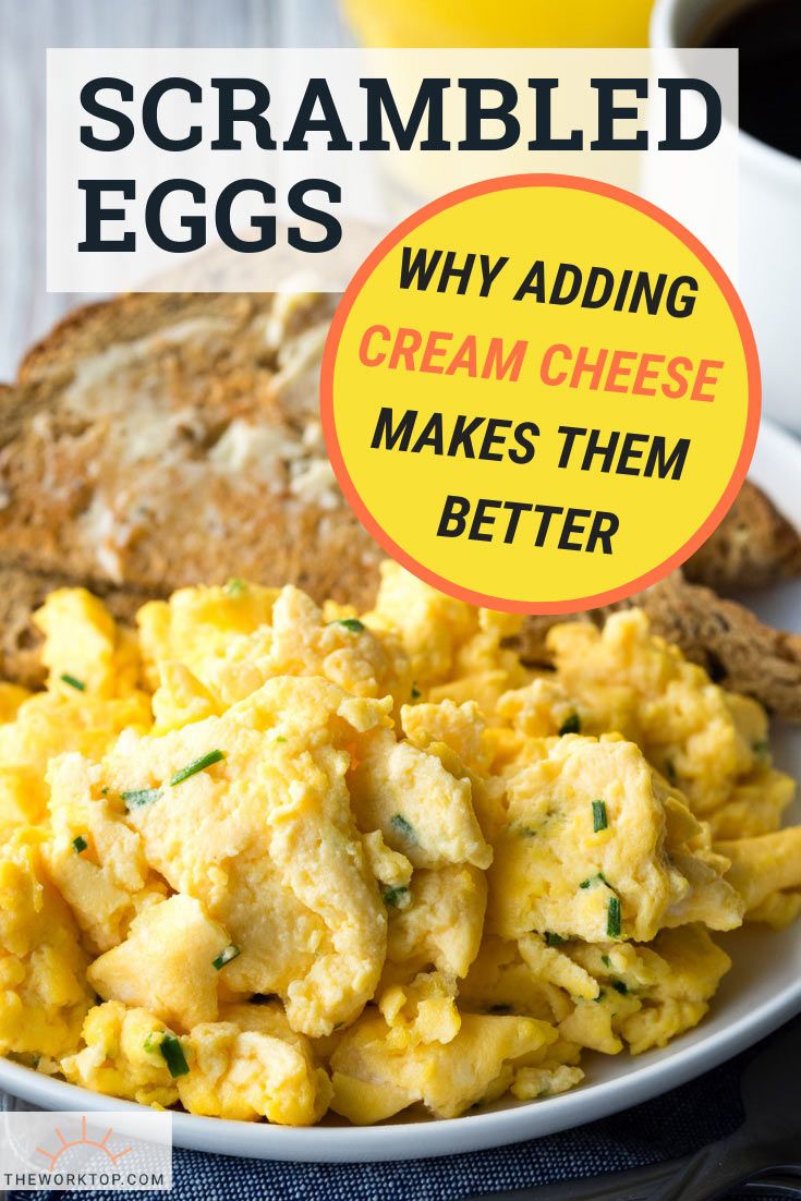 scrambled eggs on a white plate with bread and coffee in the background, text reads scrambled eggs why adding cream cheese makes them better