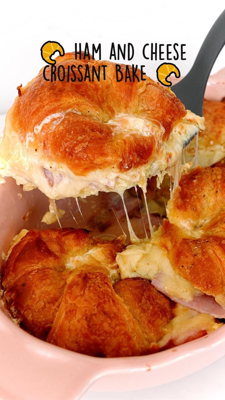 ham and cheese croissant bake is being lifted from the casserole dish