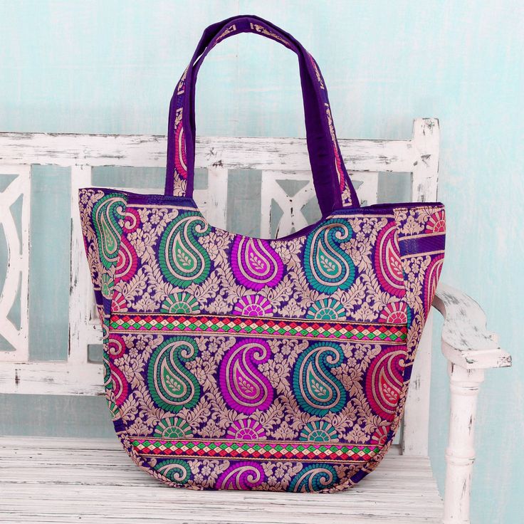 A bold paisley in fuchsia turquoise scarlet and teal circumnavigates this gorgeous shoulder bag from India's Om Prakash. The roomy purple handbag is further embellished by leafy motifs in golden brocade. Featuring a zipper closure the fully-lined bag also has an interior zipper pocket to help you stay organized. Blue Rectangular Festival Bag, Blue Rectangular Shoulder Bag For Festivals, Pink Rectangular Shoulder Bag For Festive Occasions, Festive Pink Rectangular Shoulder Bag, Festive Multicolor Rectangular Shoulder Bag, Festive Multicolor Rectangular Bags, Traditional Purple Rectangular Bag, Pink Bohemian Bags For Festive Occasions, Travel Festivals Hobo Bag