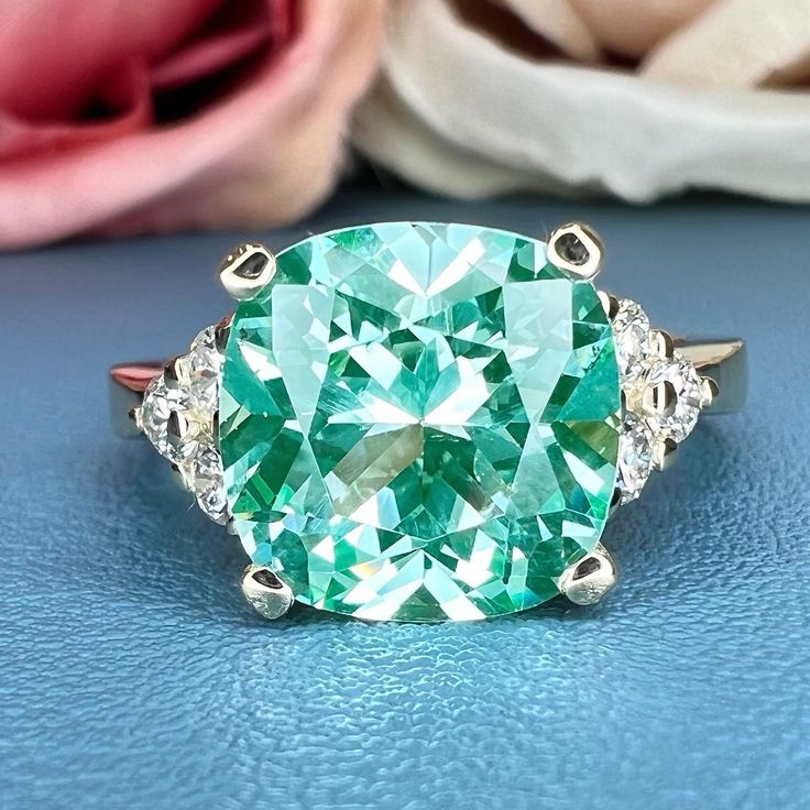 Smart Buys! Paraiba Green Tourmaline Cushion Cut Engagement Ring , 14k Gold Cushion Cut and Round Diamond Cluster Ring , Round Moissanite Accents #6525 starting from $740.00 See more. 🤓 #ParaibaTourmaline #PromiseRing #MothersDayGift #EngagementRing #DiamondRing #CushionCut #TourmalineRing #ParaibaRing #UniqueRing #ParaibaDiamond Luxury Green Cluster Ring With Rose Cut Diamonds, Luxury Cushion Cut Gemstone Wedding And Engagement Rings, Luxury Green Diamond Cluster Ring, Luxury Green Aquamarine Ring, Luxury Cluster Rings With Gemstone Accents, Luxury Collectible Cluster Ring With Center Stone, Luxury Green Cubic Zirconia Cluster Ring, Luxury Tourmaline Round Cut Ring, Luxury Classic Cushion Cut Gemstones