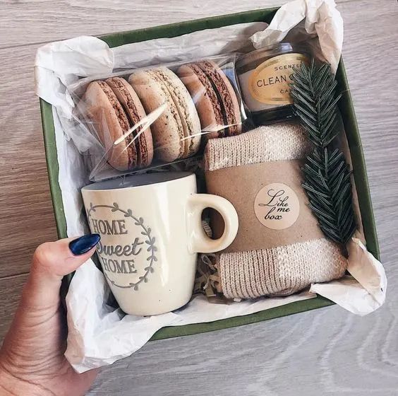 a person holding a coffee cup and some cookies