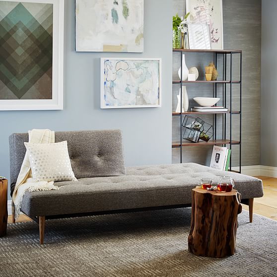 a living room filled with furniture and pictures on the wall