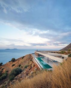 the house is on top of a hill overlooking the ocean