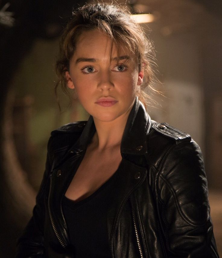 a woman in black leather jacket looking at the camera with an intense look on her face