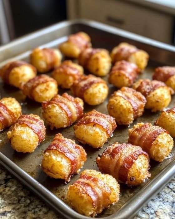 bacon wrapped bites on a baking sheet ready to be baked