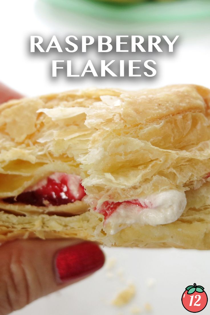 a close up of a person holding a pastry in their hand with the words raspberry flakes on it