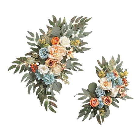 two wall hangings decorated with flowers and greenery on each side, one in the shape of a wreath