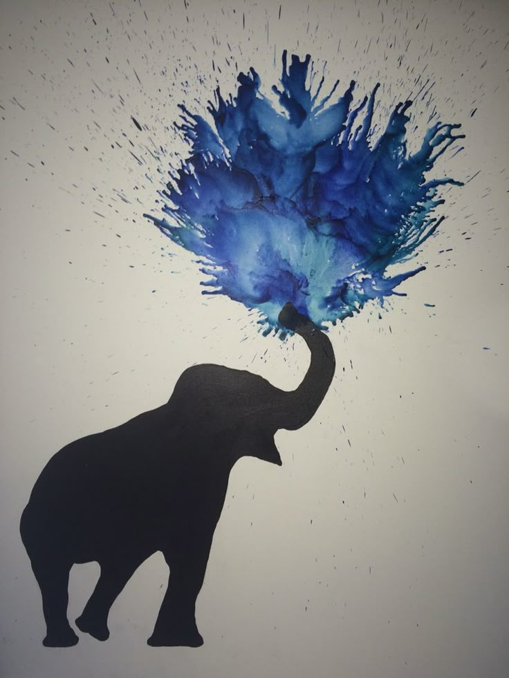 an elephant with blue paint on it's trunk and its trunk in the air