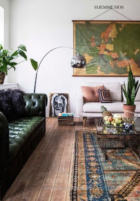 a living room filled with furniture and plants