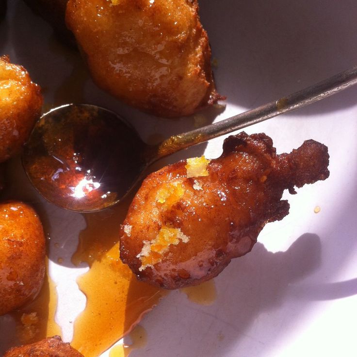 some fried food on a white plate with a spoon