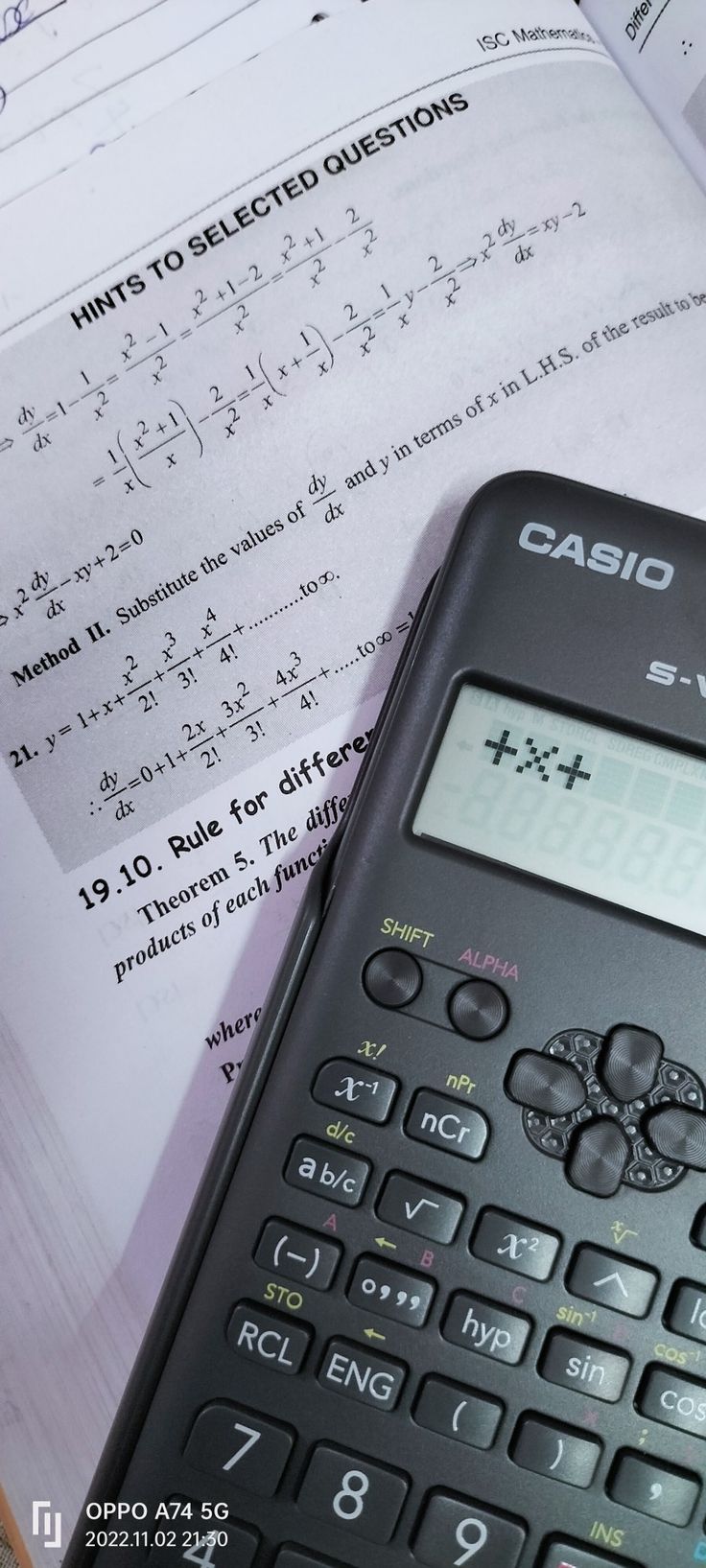 a calculator sitting on top of an open book