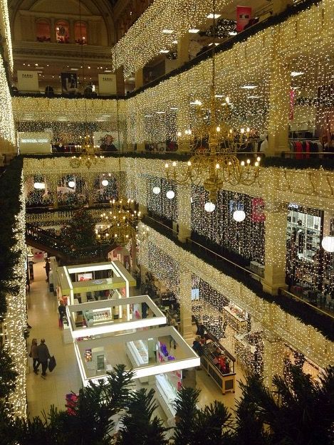 the inside of a shopping mall with christmas lights