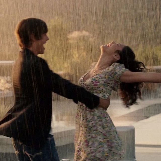 a man and woman dancing in the rain