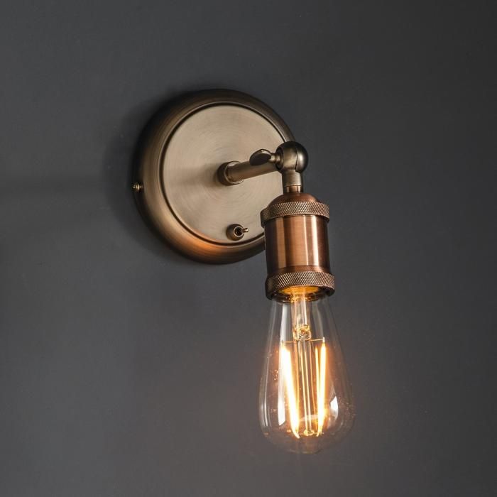 a light that is on the wall next to a lamp fixture with two bulbs in it