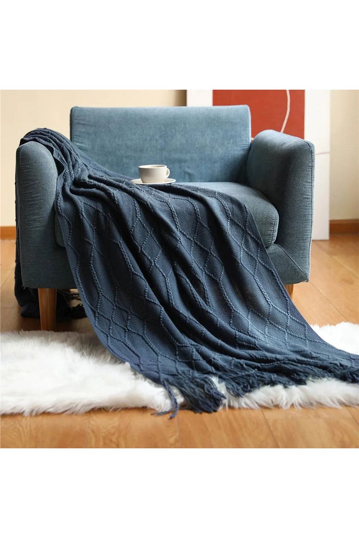 a blue chair with a blanket on it