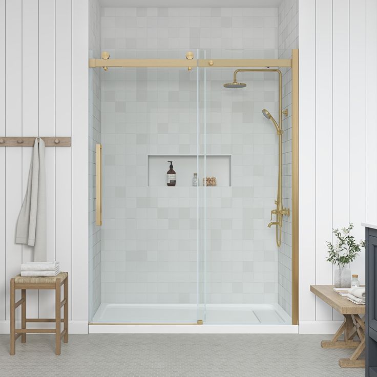 a bathroom with a walk in shower next to a wooden bench