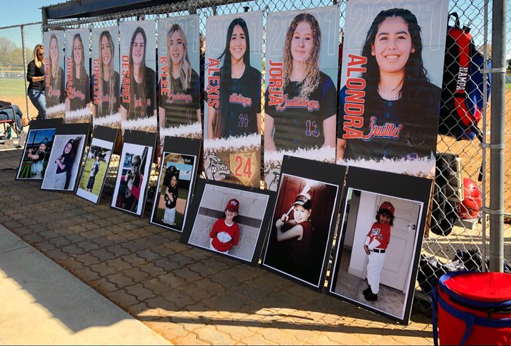 a fence covered in posters and pictures of women's softball players