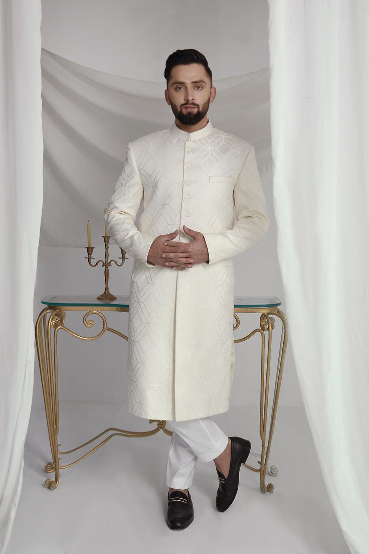 Elevate your style with our White Long Sherwani. With an off-white abstract print, this sherwani boasts a cotton silk kurta and pure cotton pajama for ultimate comfort. Perfect for special occasions, this sherwani will make you stand out in the crowd while looking sophisticated and stylish. 3-Piece Suit Designer Off-white Bandhgala For Eid, Designer Off White Kurta For Eid, Designer Off-white Kurta For Eid, Designer Cotton Kurta For Formal Occasions, Designer Off White Kurta With Resham Embroidery, Off White Naqshi Bandhgala, Designer White Nehru Jacket, Off White Naqshi Sherwani For Diwali, Designer Cotton Bandhgala For Eid