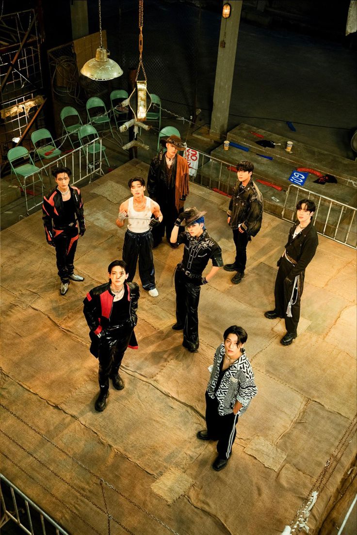 a group of young men standing on top of a wooden floor next to each other