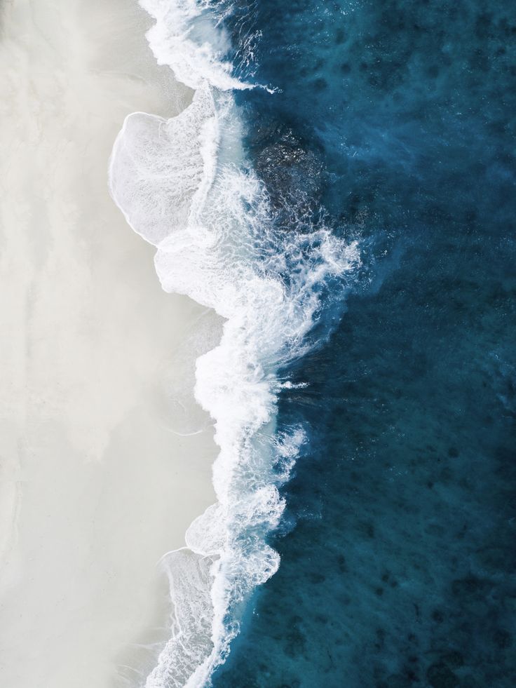 an aerial view of the ocean and beach