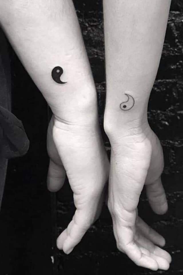 two people with matching tattoos on their arms