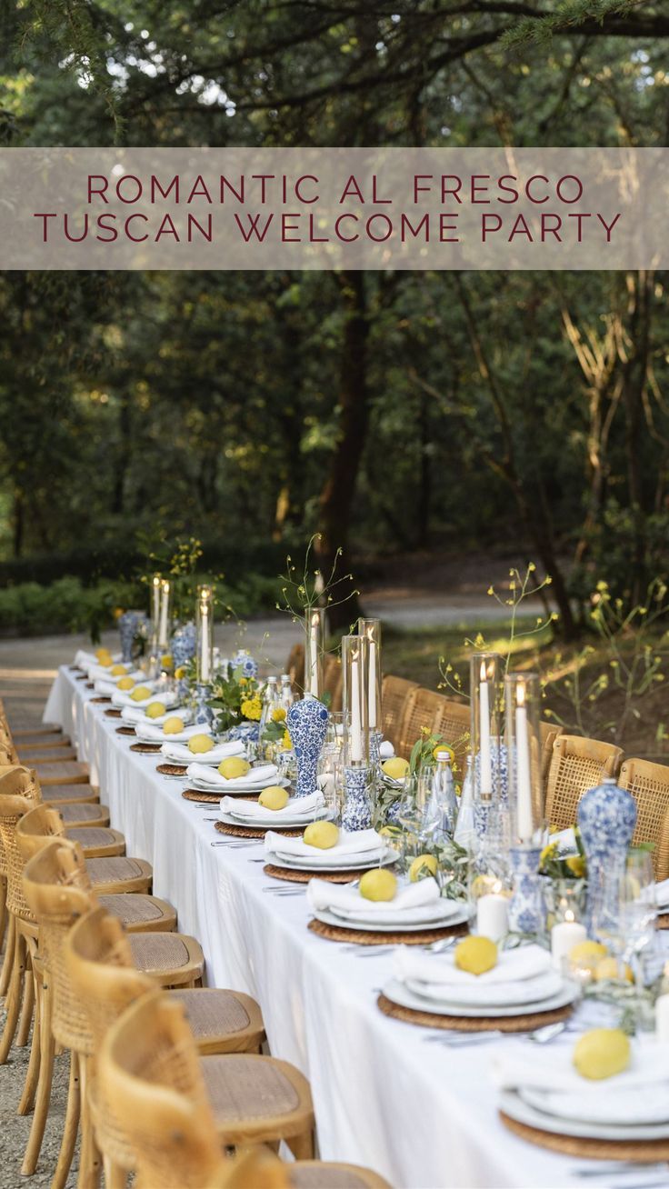 a table set up with plates and candles for a dinner party in the park or garden