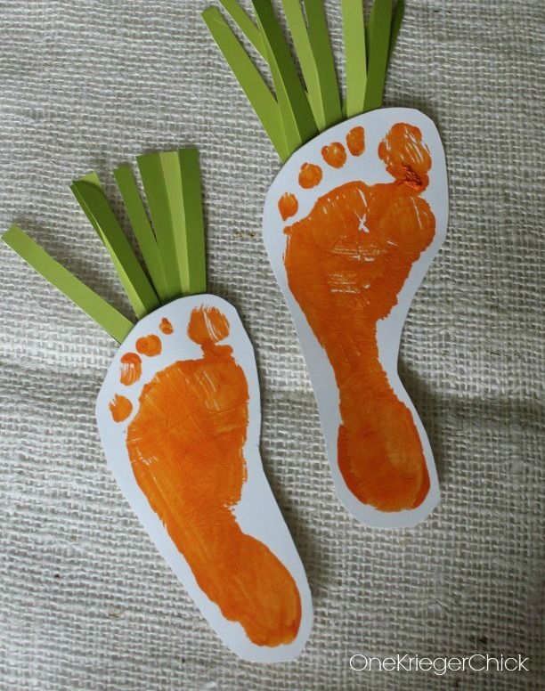 two carrots shaped like feet with green stems sticking out of the top and bottom