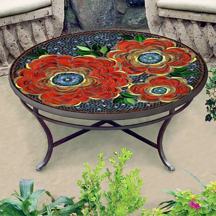 an outdoor table with flowers painted on it