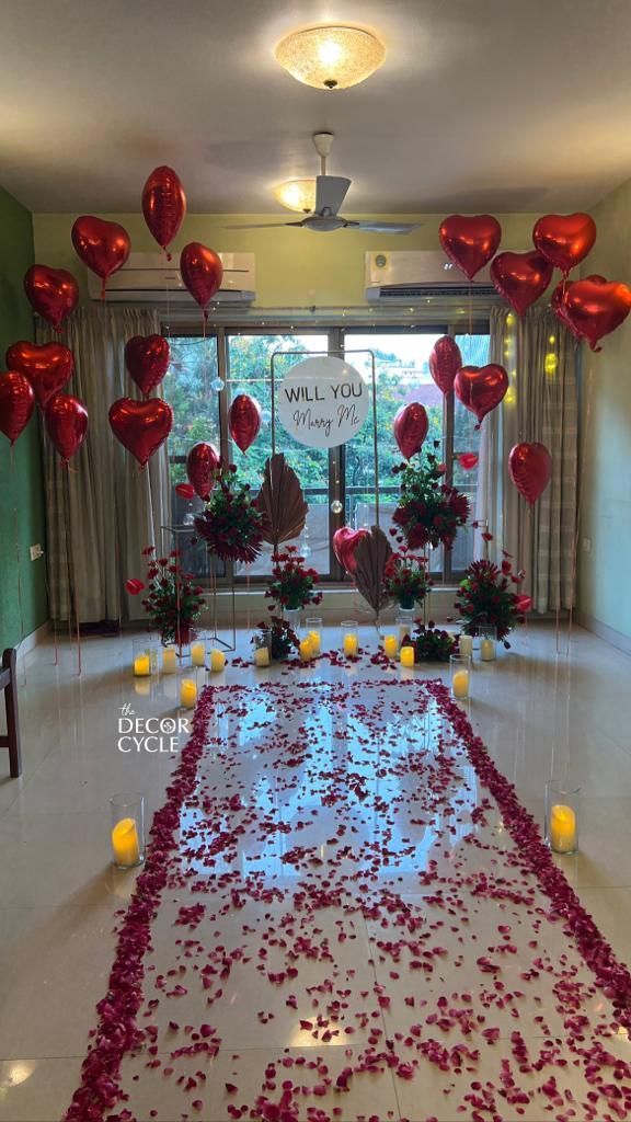 a room decorated with red and yellow balloons