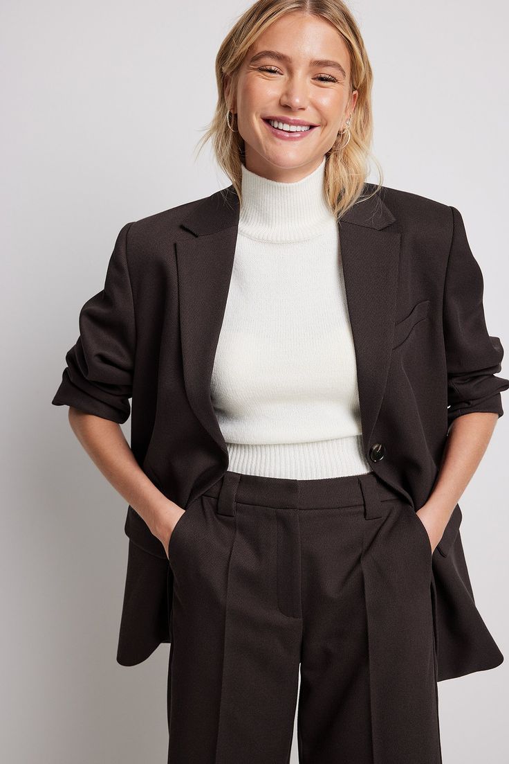 This blazer features a classic lapel neckline, shoulder pads, a mock pocket on the chest, a button closure with 2 buttons and 2 front flap pockets. Formal Brown Blazer With Welt Pockets, Brown Semi-formal Blazer With Welt Pockets, Semi-formal Brown Blazer With Welt Pockets, Brown Business Blazer With Suit Collar, Brown Notch Lapel Blazer For Business Casual, Brown Notch Lapel Blazer For Office, Brown Notch Lapel Formal Blazer, Brown Blazer With Hidden Button For Business, Brown Blazer With Hidden Button Closure For Business