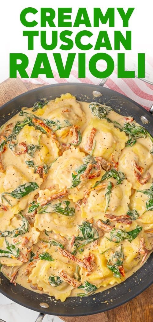 creamy tuscan ravioli with spinach in a skillet on a wooden table