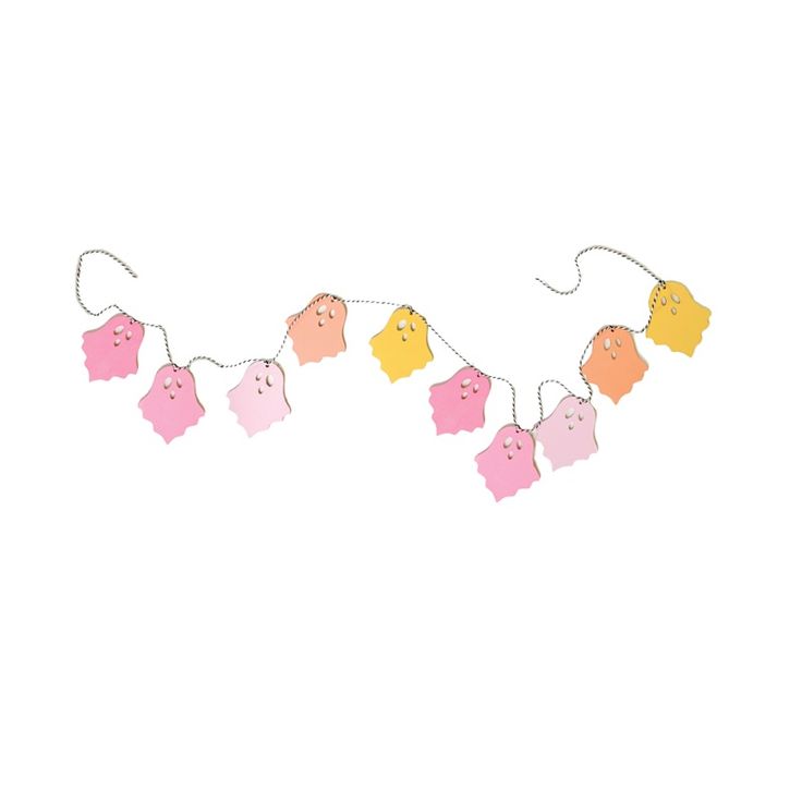 some pink and yellow pigs hanging from a string