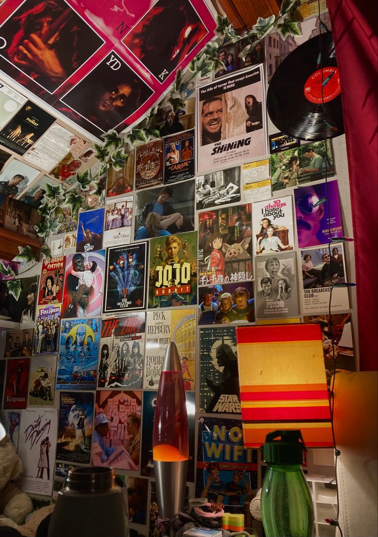 a room filled with lots of different types of posters on the wall and ceiling above it