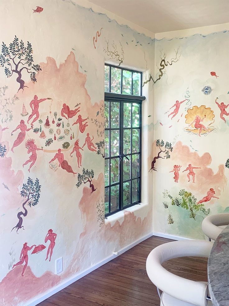 a dining room with wallpaper and table next to a window in the middle of it