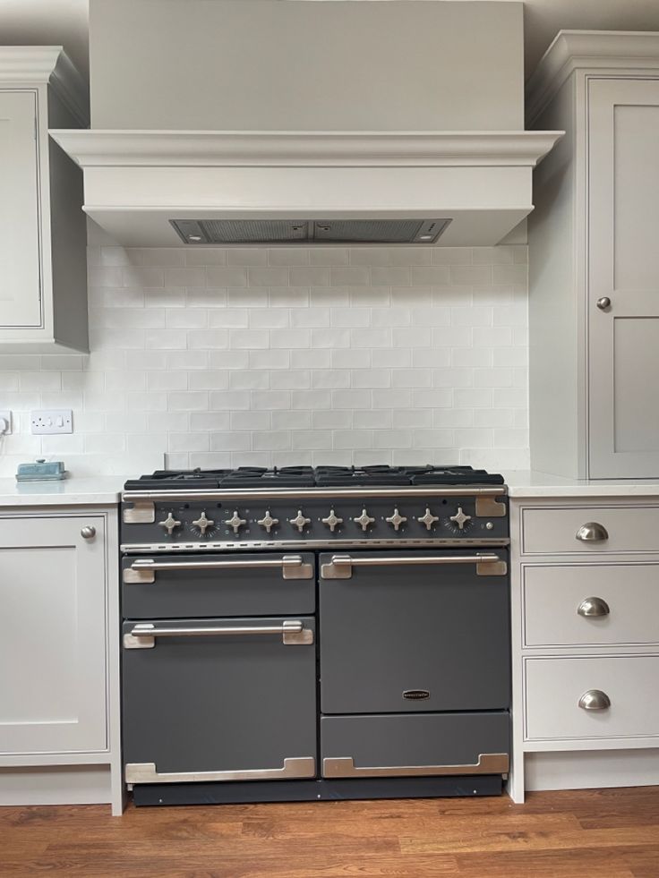 French style range cooker with white matt tile backsplash Belling Farmhouse Range Cooker, Rangemaster Elise 110, White Range Cooker Kitchen, Rangemaster Elise 110 In Kitchen, Hidden Cooker Hood, Range Cooker Hood, Cooker Backsplash Ideas, Rangemaster Cooker Kitchen, Shaker Kitchen With Range Cooker