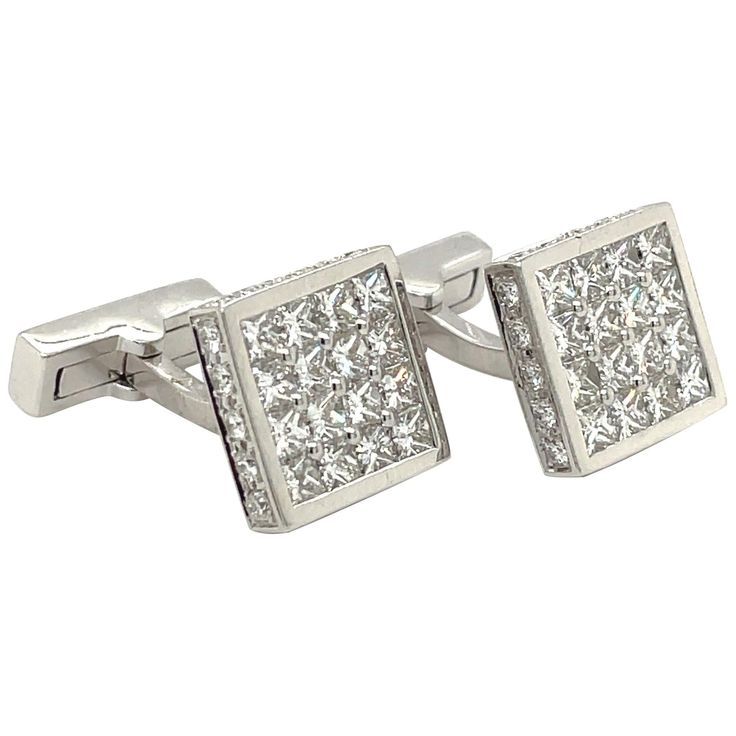 Magnificent pair of 18 karat white gold square diamond cuff links. The cuff links are invisibly set with princess cut diamonds. The entire border of the cuff links are set with round brilliant diamonds. The collapsible bar backs are also set with a row of princess cut diamonds. The cuff links measure 12.6 mm. Princess cut diamonds 4.65 carats Brilliant cut diamonds 1.00 carats Stamped 750 Luxury Diamond Cufflinks For Anniversary, Luxury Silver Diamond Cufflinks, Luxury Diamond Cufflinks, Elegant Diamond Cufflinks, Luxury Diamond Cufflinks With Polished Finish, Classic White Gold Diamond Cufflinks, Formal Diamond Cufflinks With Polished Finish, White Gold Diamond Cufflinks For Formal Occasions, Diamond Cufflinks With Polished Finish For Formal Events