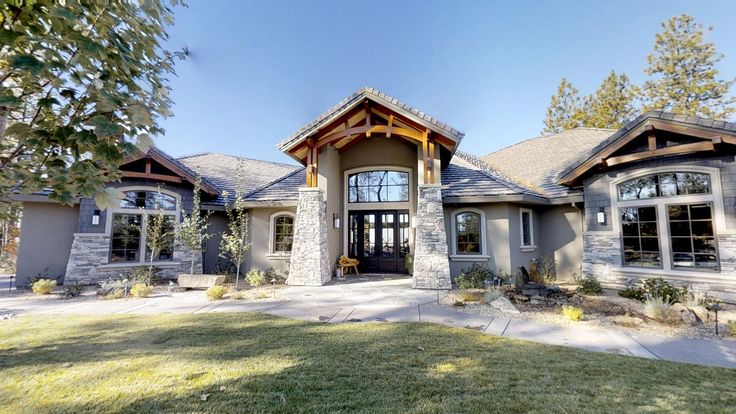 a large house with lots of windows in the front yard