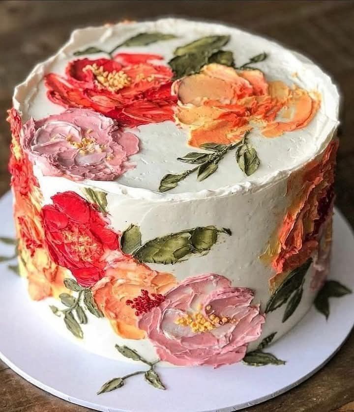 a white cake with flowers painted on it