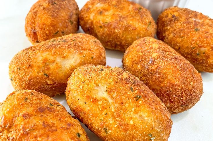 some fried food is sitting on a white tablecloth and it looks like they are ready to be eaten