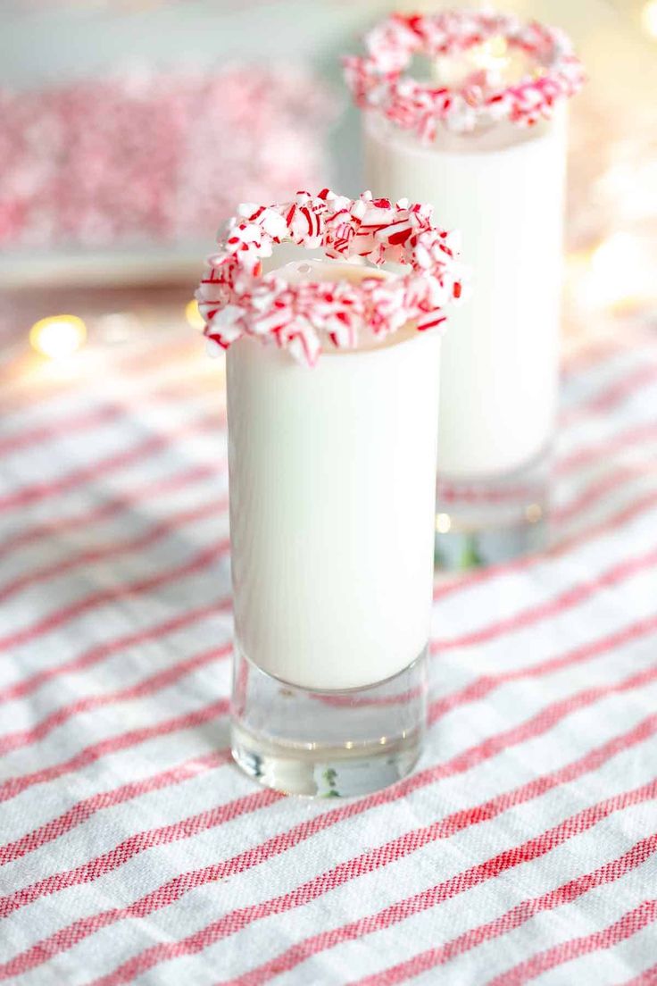 two glasses filled with white and red candy canes