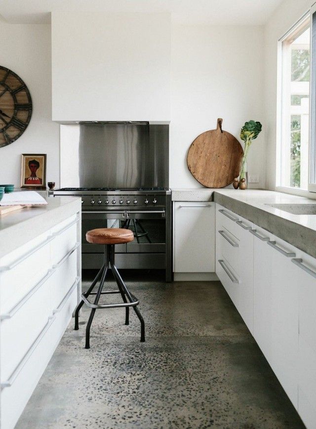 a kitchen with an oven, counter and stools in it's center island