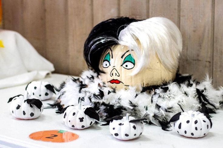 an old doll with white hair and black feathers