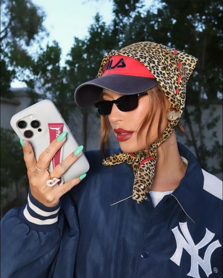 Bandana Streetwear Outfit, Hailey Bieber Cap Outfit, Baseball Cap And Scarf, Hat With Scarf On Top, Carhartt Beanie Hairstyles, 2024 Hat Trend, Hailey Bieber Scarf, Cheetah Bucket Hat Outfit, Scarf Hat Outfit