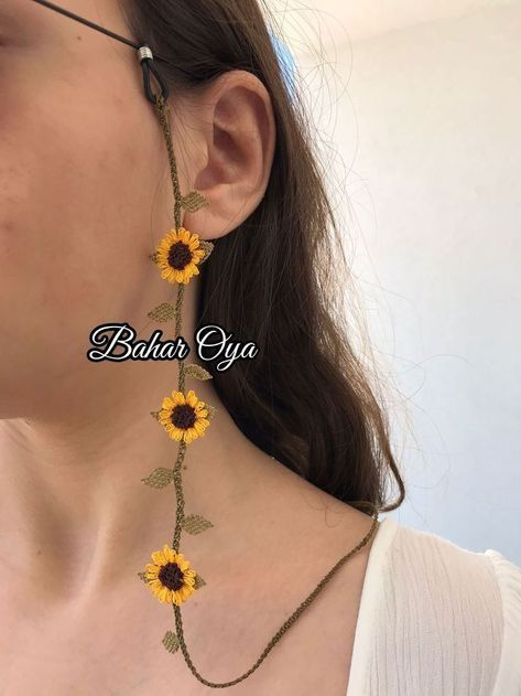 a woman wearing sunflowers on her necklace