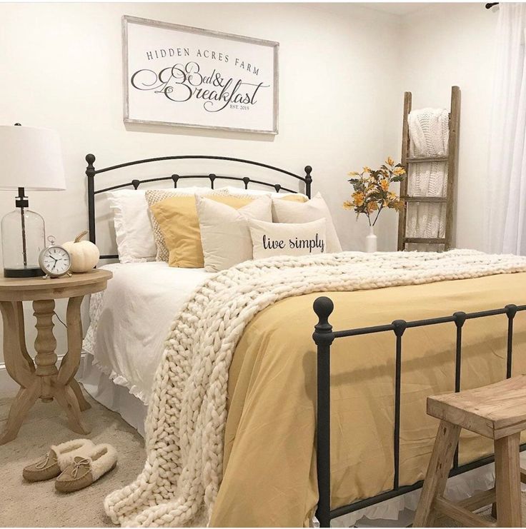 a bed room with a neatly made bed and a wooden chair next to it on the floor