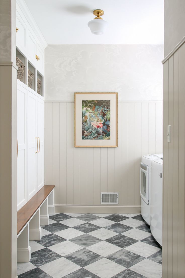 a white washer and dryer sitting next to each other in a room with checkered flooring